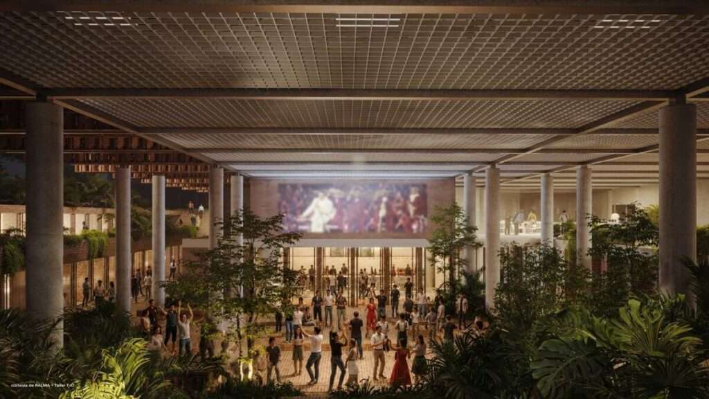 A nighttime exterior view of a central courtyard with a large crowd gathered under a grid ceiling supported by concrete columns.