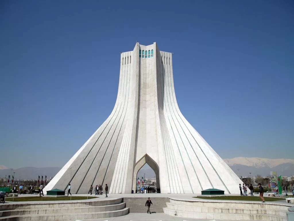 Interior fisheye view of the geometric concrete vaults and ceiling architecture inside the main hall of the Azadi Tower.