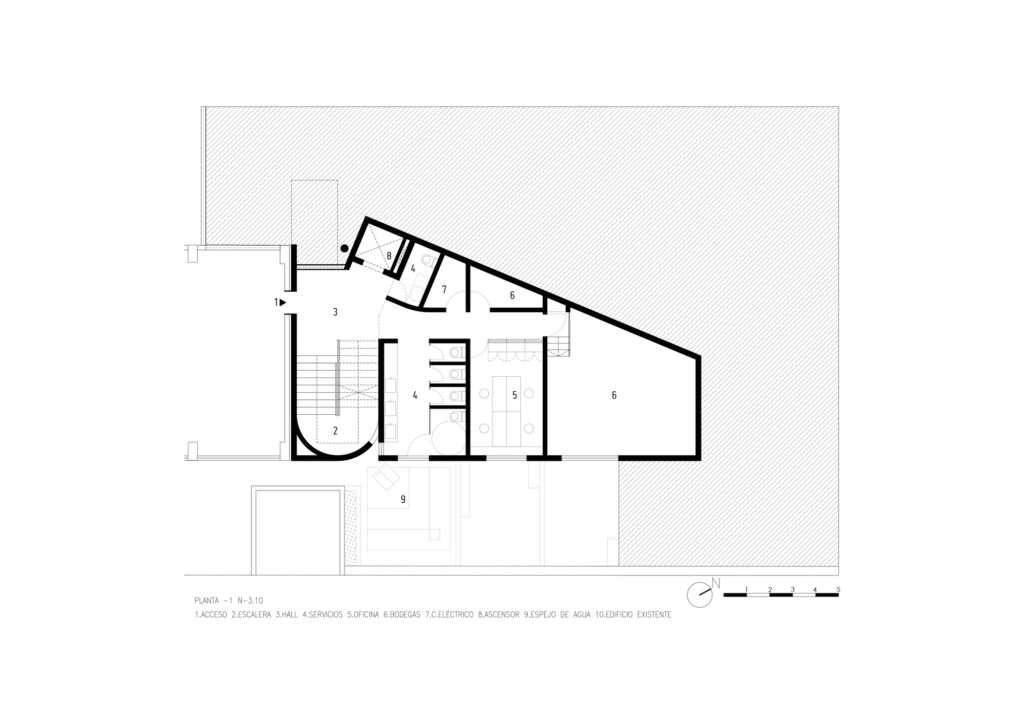 Black and white architectural floor plan drawing of the basement level, showing service zones, offices, and storage layouts within a trapezoidal boundary.