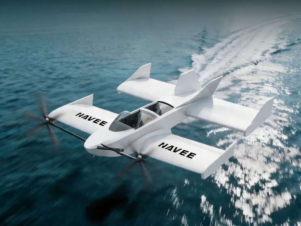 Aerial view of the all-white Navee WaveFly 5X flying watercraft cruising smoothly just above the blue ocean surface, showcasing its unique tandem-wing design and aerodynamic hull.
