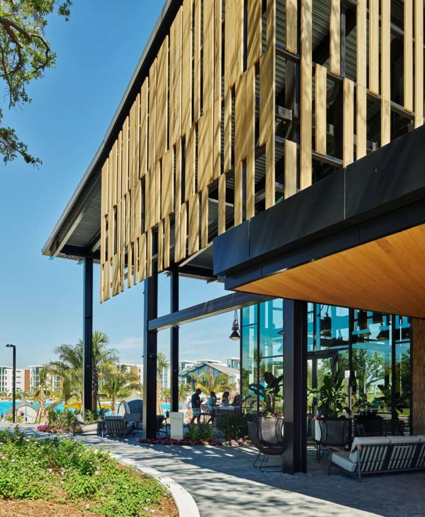 Open-air outdoor dining terrace at The Landing with views towards the beach, lagoon, and surrounding tropical resort elements.