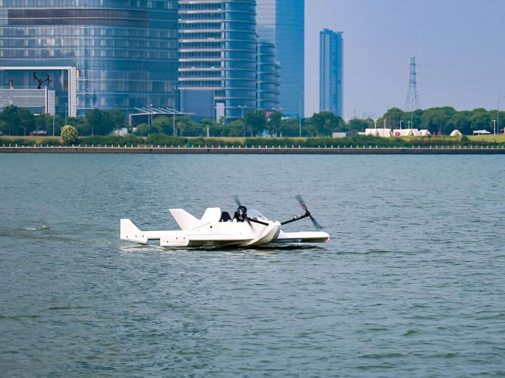 Side view of the Navee WaveFly 5X on Taihu Lake in Suzhou, with a modern city skyline and glass skyscrapers stretching into the background.