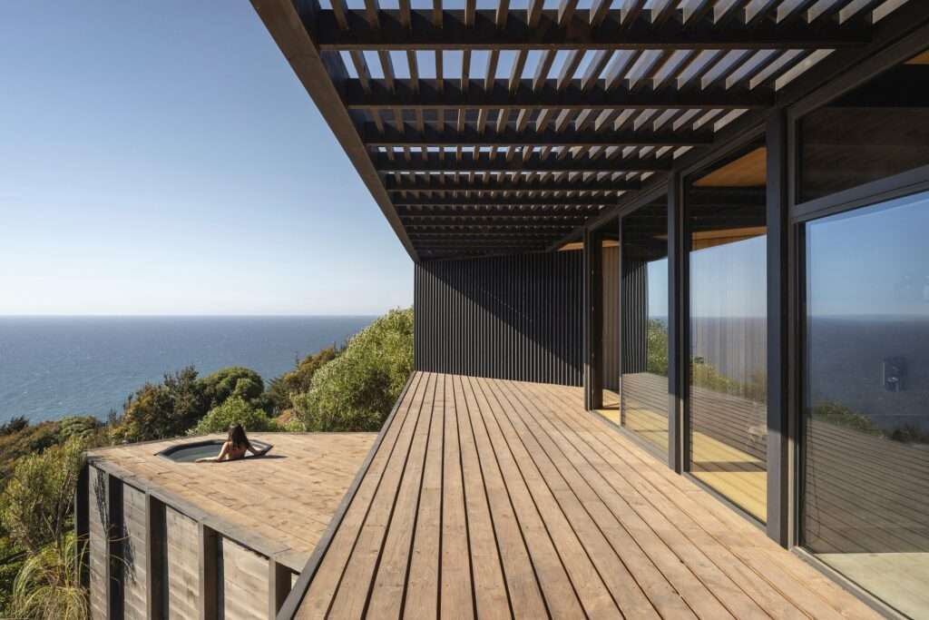 Wooden terrace of the Matanzas Beach House with a hot tub overlooking the ocean.