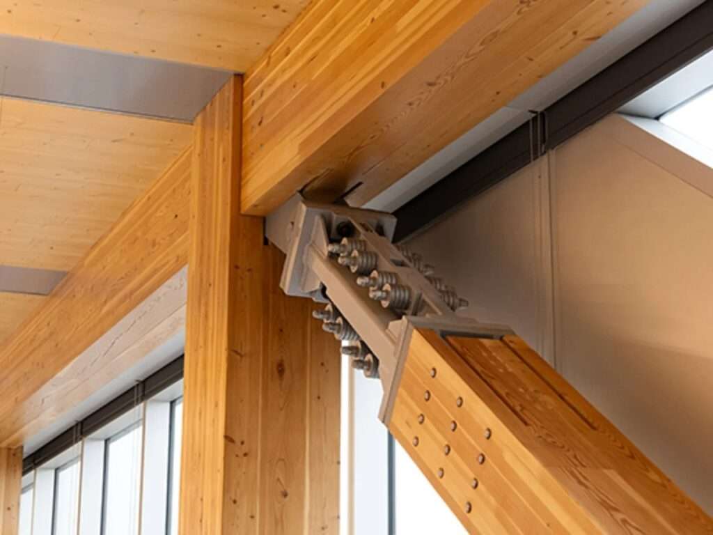 Close-up of a Tectonus seismic damping connection installed on a glulam timber beam in The Hive building.