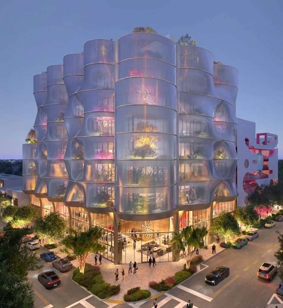 A close-up photograph capturing the textured, reflective mesh of the Sweetbird North facade, showing its golden hue and interplay with integrated plants during the day.