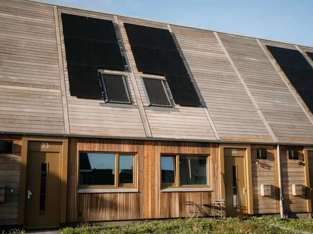 Modern timber-clad social housing units in Marknesse, Netherlands, demonstrating prefabricated sustainable architecture.
