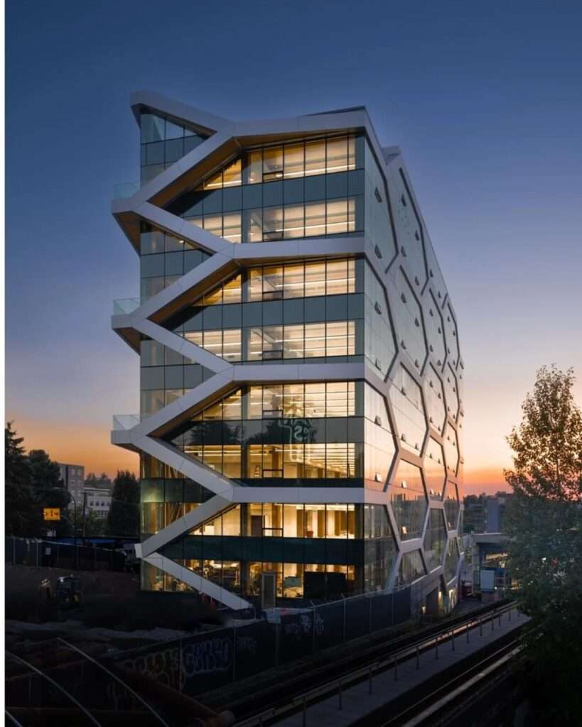 Dusk view of The Hive in Vancouver, showcasing the honeycomb glulam grid and transparency of the mass timber office structure.