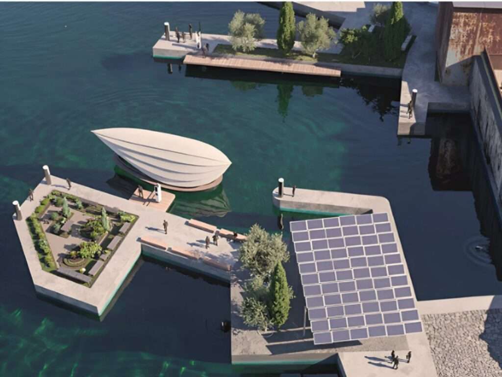 Aerial view of a solar-powered floating dock facility called Darsena Link with solar panels, green gardens, and a Lucia floating unit moored alongside.