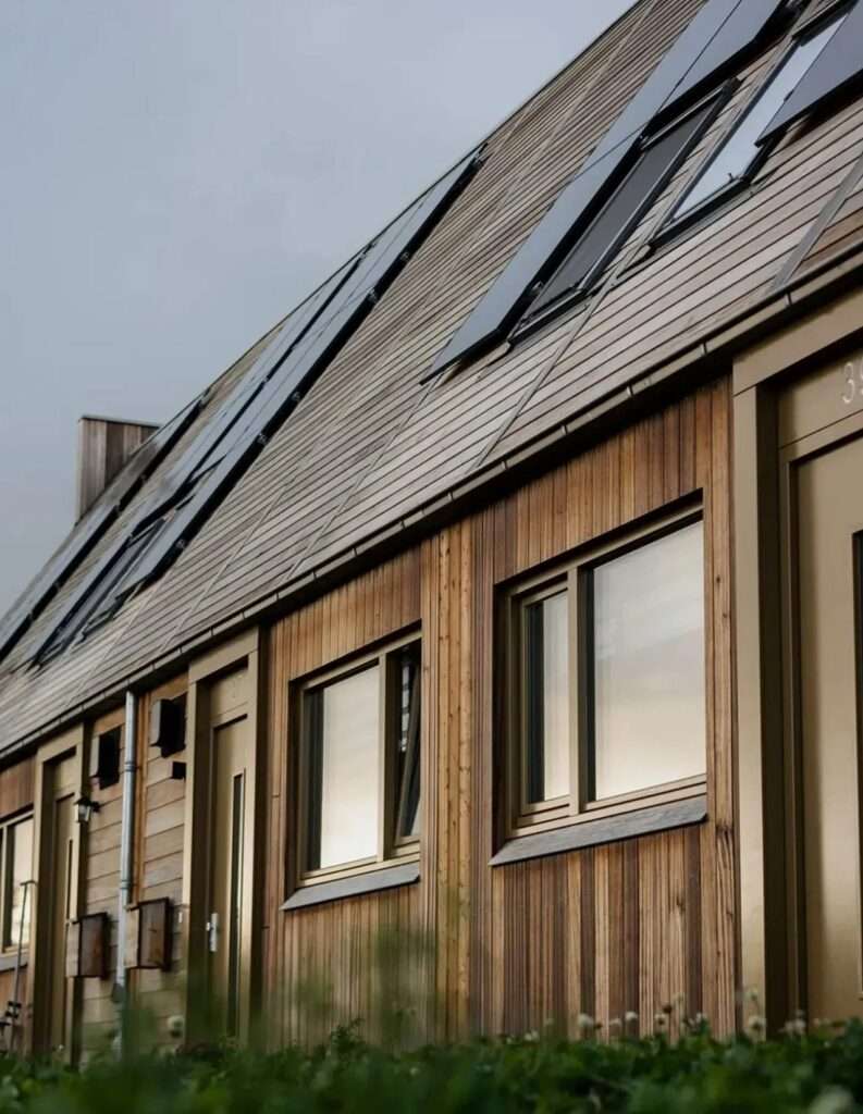 Side angle view of carbon-negative housing in Marknesse showing roof pitch and sustainable wood construction.