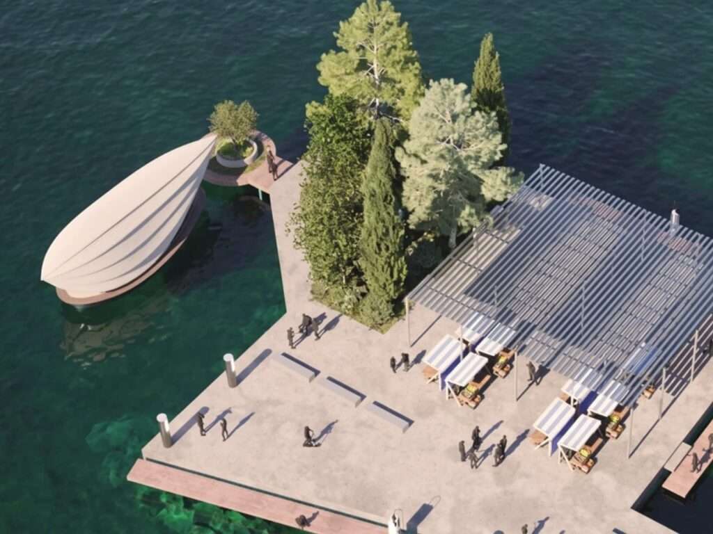 Top-down view of a floating public market dock with shaded white-and-blue canopies and a Lucia vessel docked next to it on clear green water.