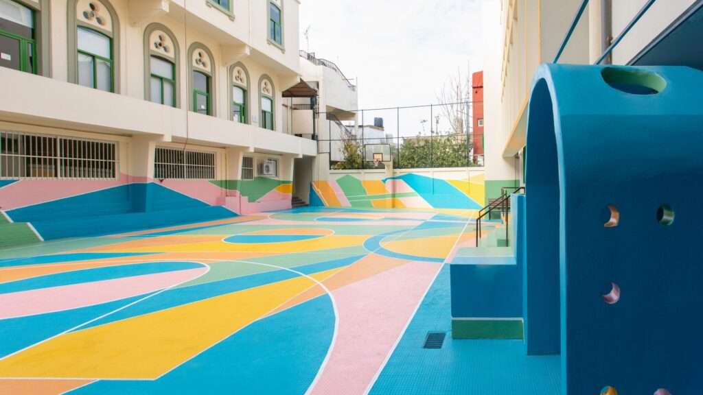 Wide angle view of a colorful empty school playground after renovation.
