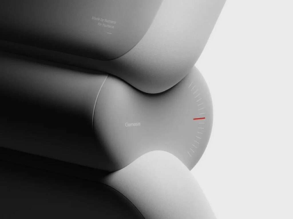 Extreme macro shot of the curved joint casing of Enno robot showing the etched Genesis brand name and fine graduation lines.