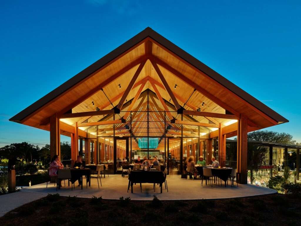 Dramatic symmetrical twilight view of the Twin View restaurant gable pavilion illuminated from within.