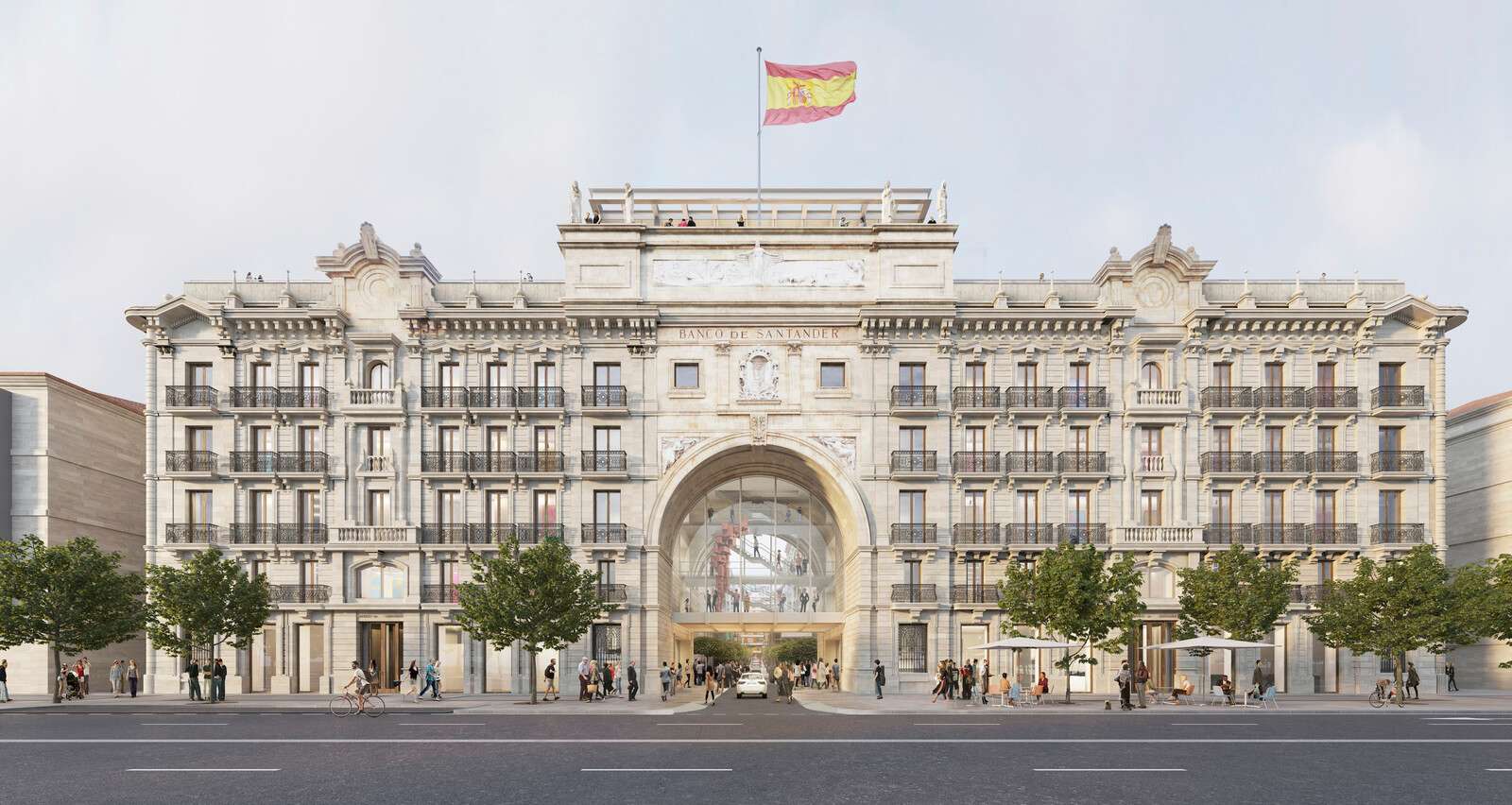 Exterior elevation of a classical historic stone building with a central monumental archway and a Spanish flag on top.