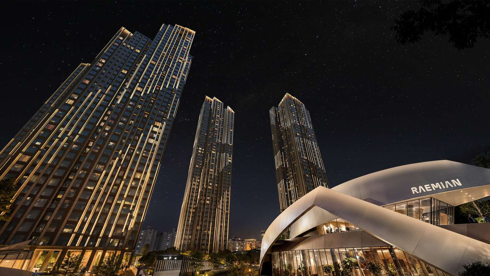 Night view of illuminated high-rise residential towers and a curved pavilion with Raemian signage under a starry sky.