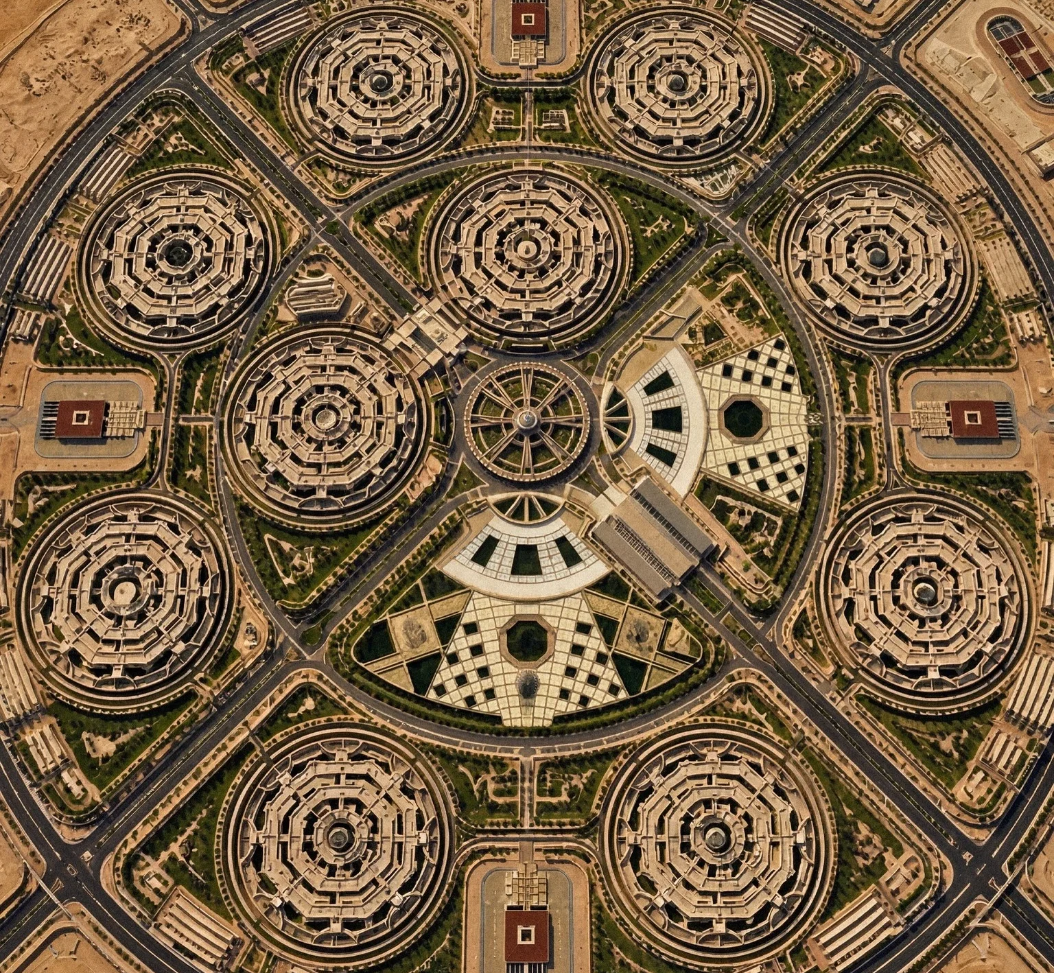 High-altitude aerial view of an expansive military command city arranged in a series of interconnected octagonal building clusters.