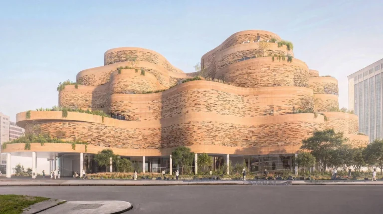 Street-level elevation of a terraced earthen building with horizontal facade slots and lush greenery.