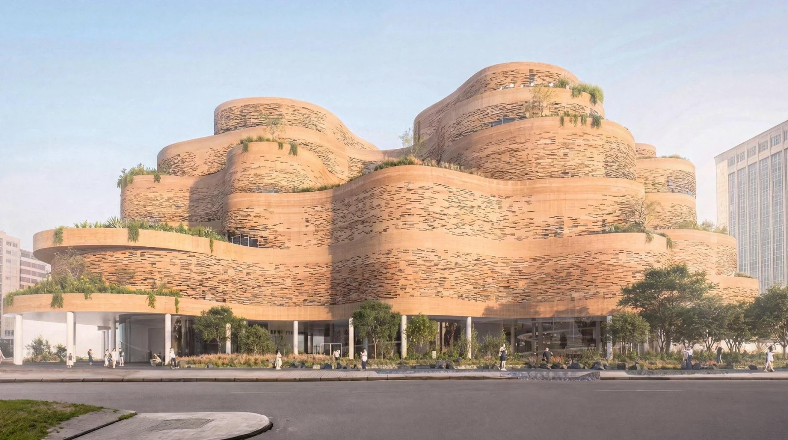 Street-level elevation of a terraced earthen building with horizontal facade slots and lush greenery.