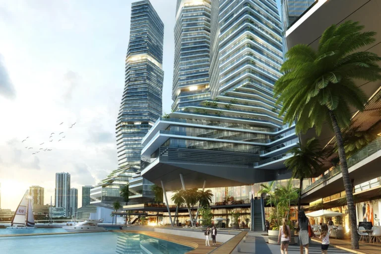 Pedestrian promenade with palm trees adjacent to a stepped podium and sculptural towers.