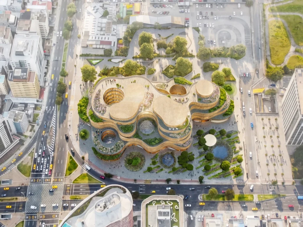 Top-down overhead view of fluid terraced roof structures, inner courtyards, and landscaped plaza grounds.