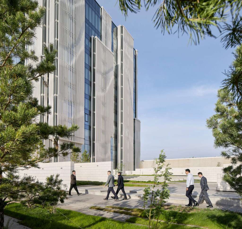 A close-up view of the building's facade modules made of vertical stone fins and glazing.