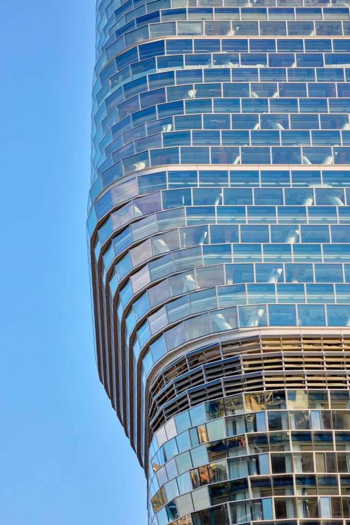 Close-up detail of the faceted glass envelope and steel structure of Atlassian Central facade.