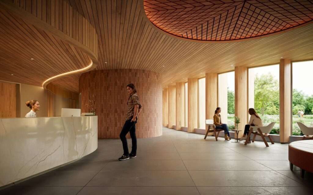 Modern reception hall featuring a curved stone desk, timber-clad ceiling, and large vertical windows.