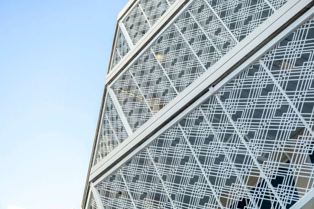 Low-angle shot of the Indonesian Consulate building in Jeddah, focusing on the dynamic Batik-patterned sun shading facade.
