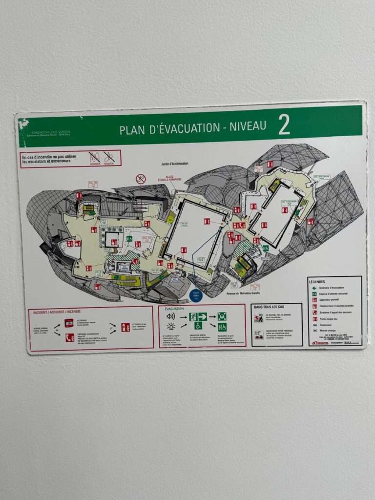 Wall-mounted level 2 emergency evacuation plan displaying the complex, asymmetrical architectural floor layout, safety routes, and legends for the Fondation Louis Vuitton.