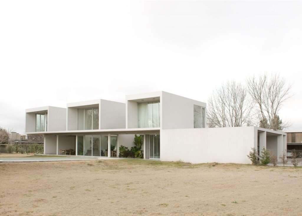 Casa O North Facade Open to Large Garden and Pool with Transparent Windows and Cantilevered Cubes.