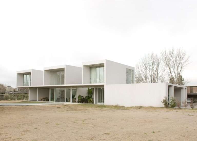 Casa O North Facade Open to Large Garden and Pool with Transparent Windows and Cantilevered Cubes.