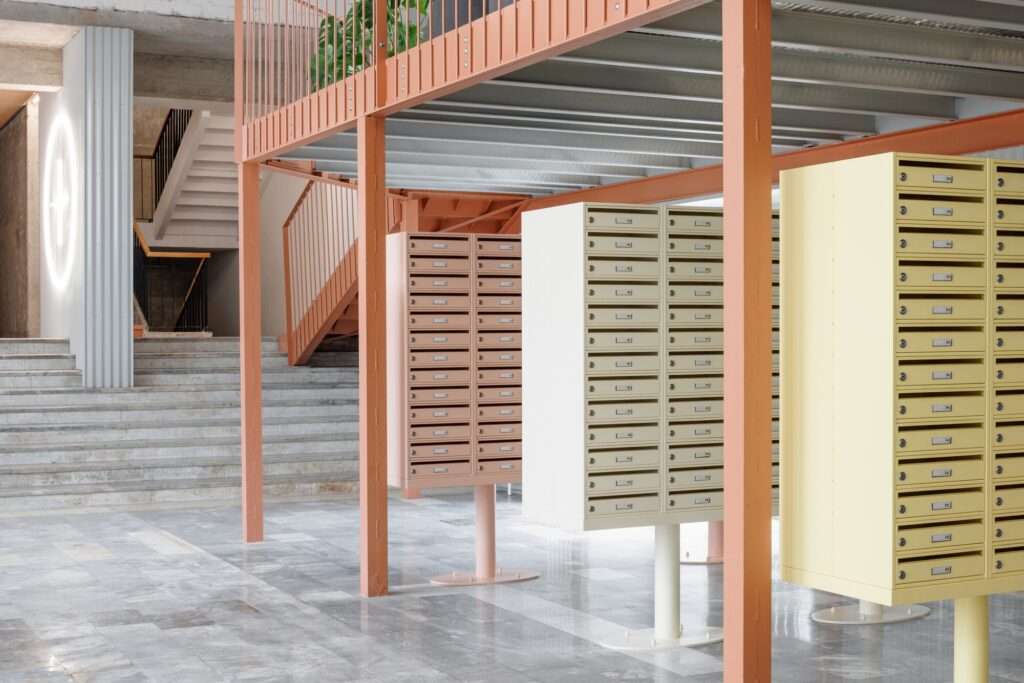 Pastel yellow and salmon-colored freestanding mailboxes in the terrazzo-floored lobby of the Terasa housing complex.