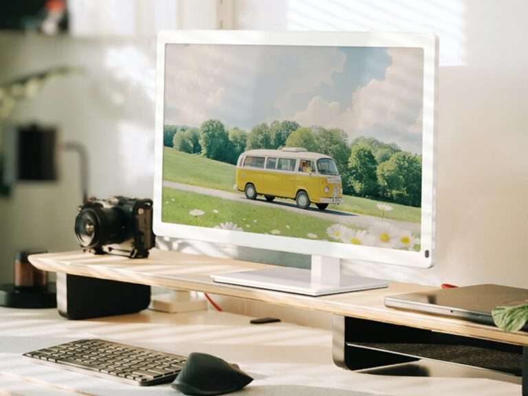 Bigme B251 Pro 25.3-inch E Ink color monitor displaying a vibrant landscape on a desk setup.