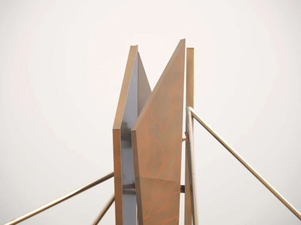Close-up of vertical weathering steel panels with etched line patterns on a light background.