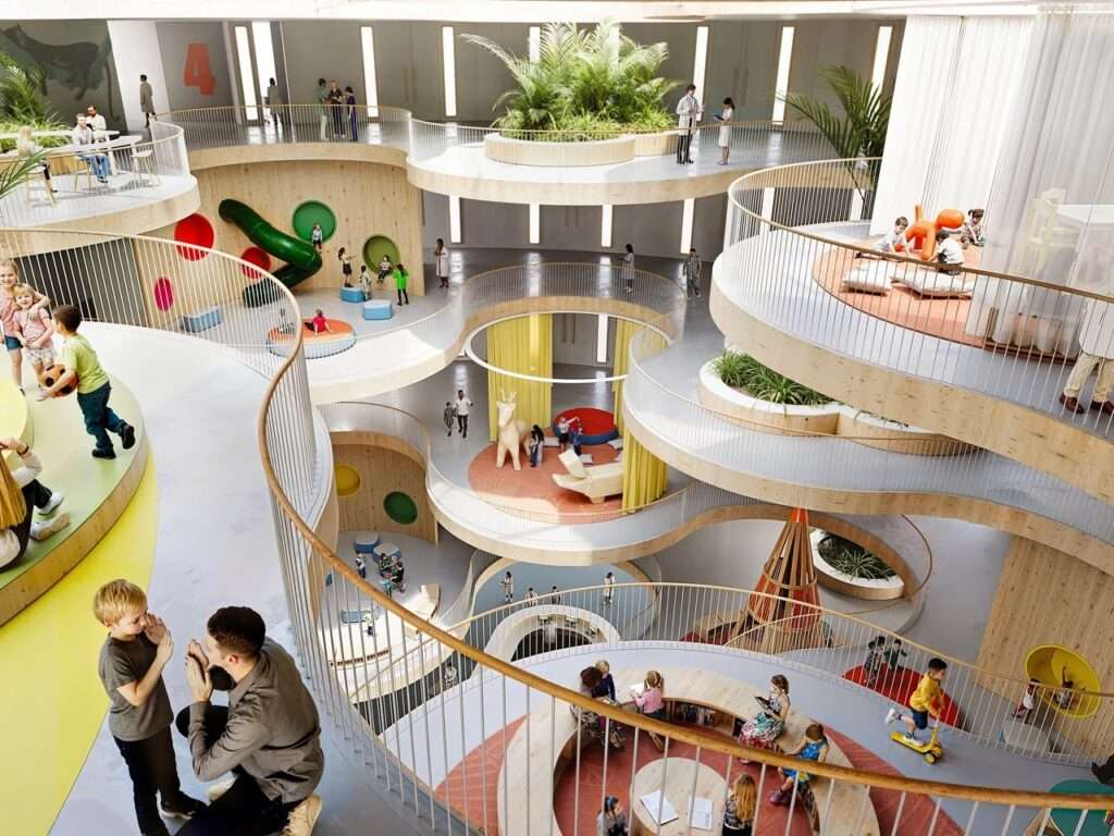 Internal view of the children's hospital featuring multi-level curved wooden balconies, central play areas, slides, and indoor palms.