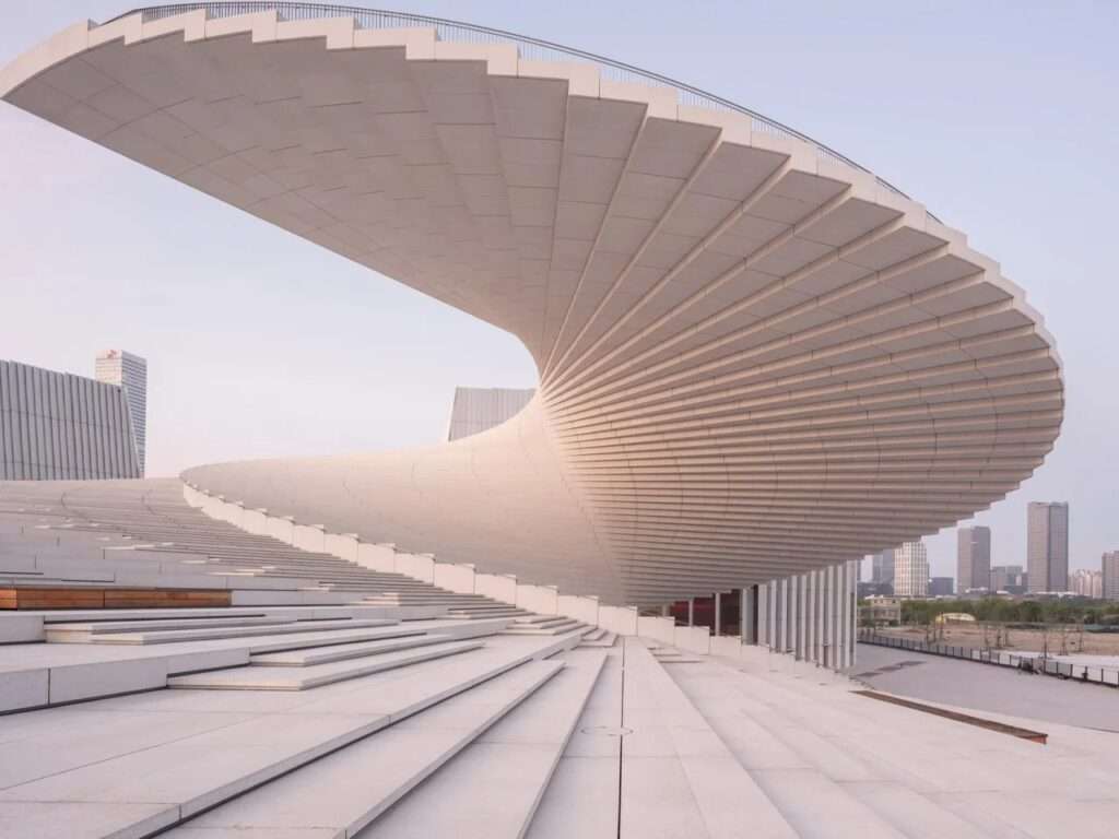 Close-up of the expansive white exterior spiral staircase of the Shanghai Grand Opera House.