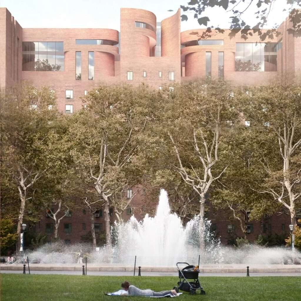 A large active water fountain in a public park with a woman resting on the lawn, framed by lush trees and the modified upper stories of the Stuyvesant Town buildings.