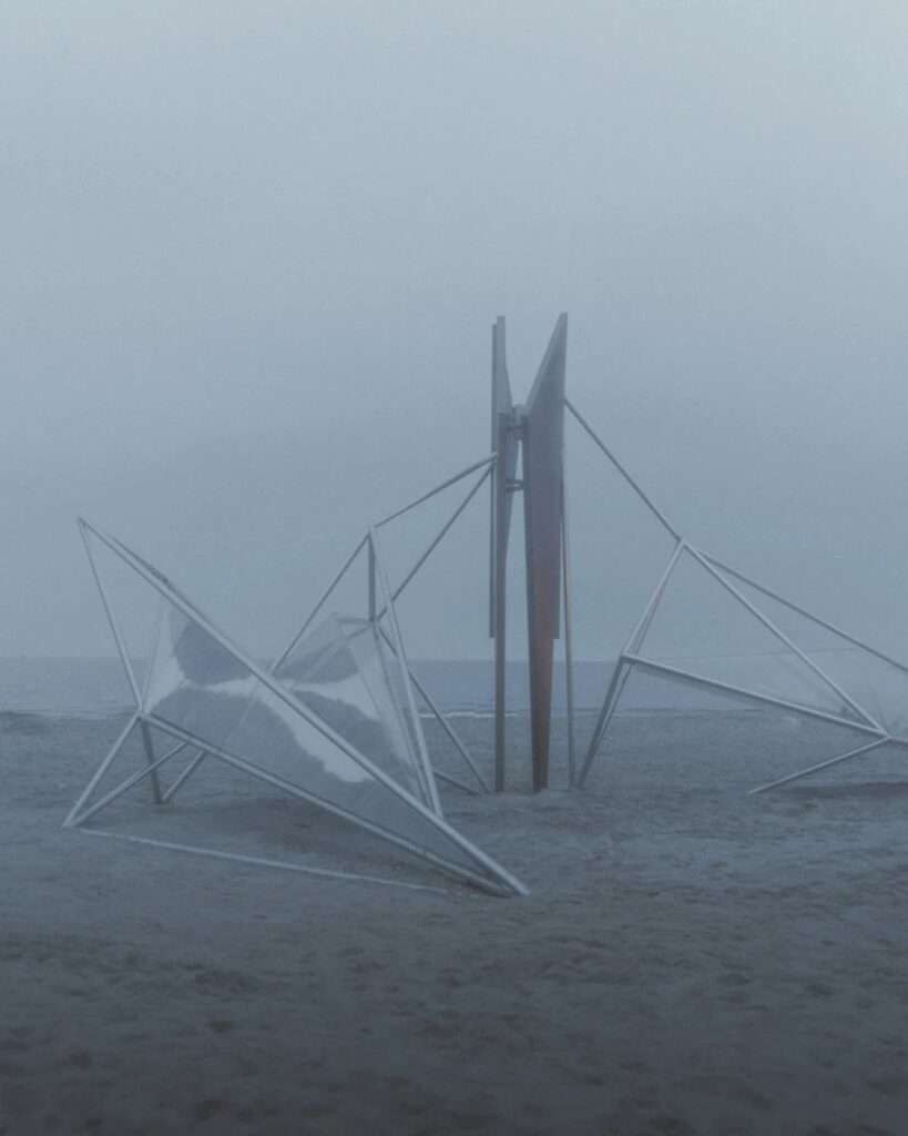 Minimalist metal frame installation on a beach shrouded in thick gray fog.