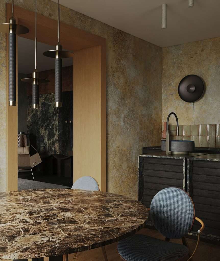Close-up of a round marble dining table with modern chairs looking into the open kitchen area.