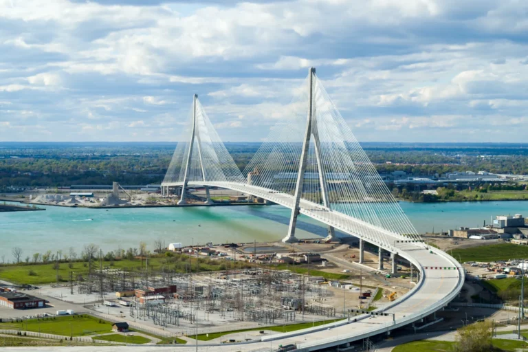A six lane cable stayed bridge stretching across the river connecting highway infrastructure on both sides.