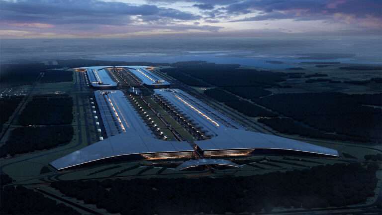 Aerial rendering of the expansive Terafab complex at dusk, showing symmetrical factory wings and central circulation.