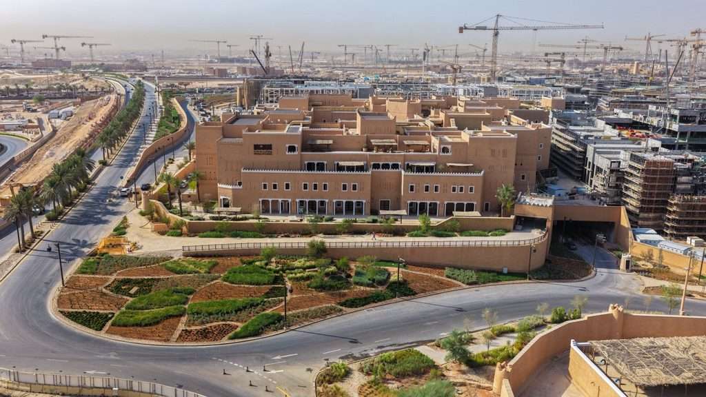 Elevated view showing the Ministry facade facing a landscaped curve and road infrastructure.
