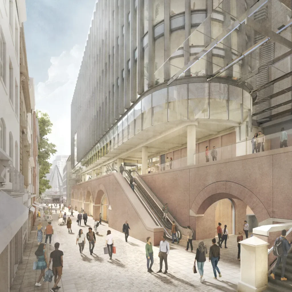 Street-level view of a brick vault arcade with escalators and pedestrians walking alongside.