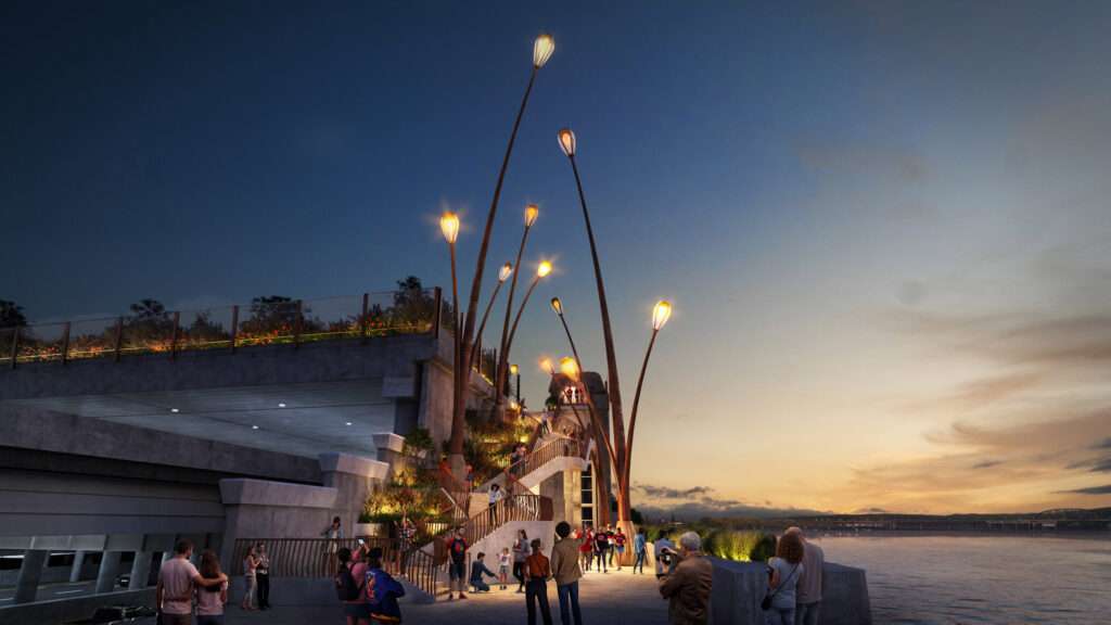 A concrete staircase with lighting posts connecting the elevated park deck to the riverbank.