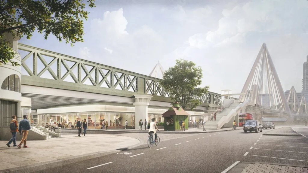 Glazed ground-floor frontage underneath an overhead railway truss bridge with pedestrians and cyclists.