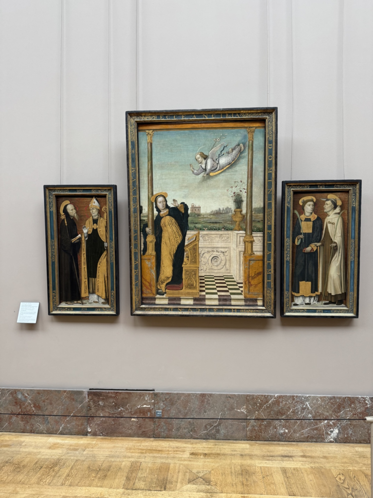 Carlo Braccesco's Annunciation Triptych circa 1490-1500, with a dynamic angel and Virgin Mary inside an architectural loggia, flanked by standing saints against dark backgrounds.