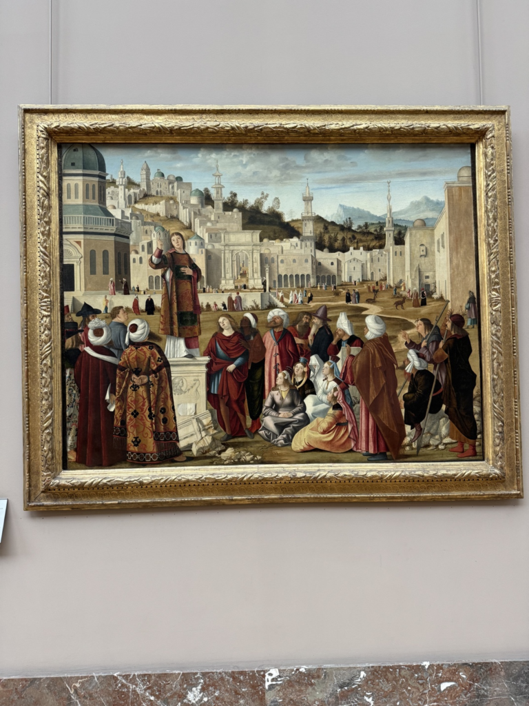 Vittore Carpaccio's Saint Stephen Preaching in Jerusalem circa 1514, with the saint on a classical pedestal preaching to a crowd against an imagined Eastern cityscape with domes and minarets.