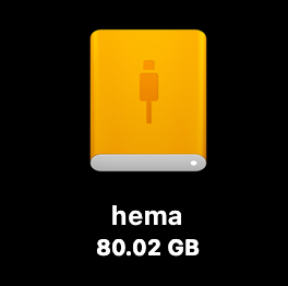 A digital interface icon of an orange external hard drive against a black background, labeled with the name "hema" and a storage capacity of "80.02 GB"