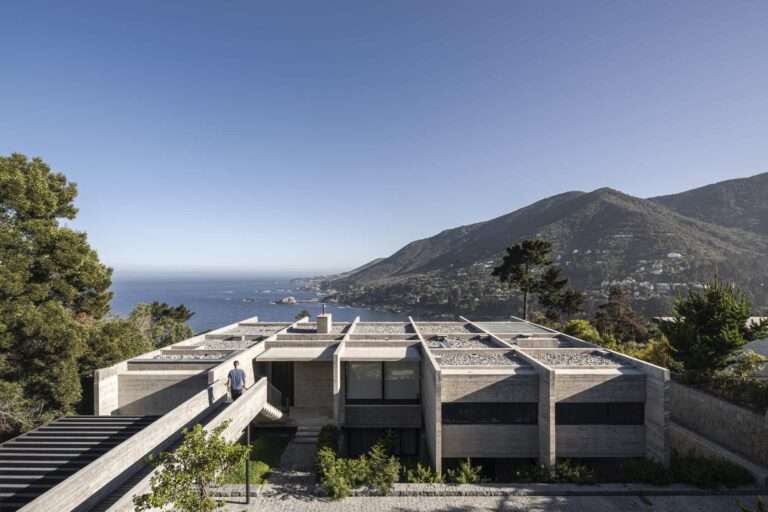 Aerial top view of Casa Zapallar showcasing the modular board-formed concrete grid roof overlooking Zapallar Bay and the surrounding coastline.