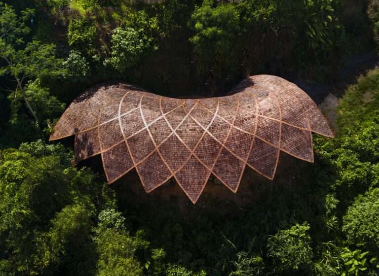 Aerial top-down view of the Lotus Shala bamboo roof structure inspired by blooming lotus petals in Ubud foliage.